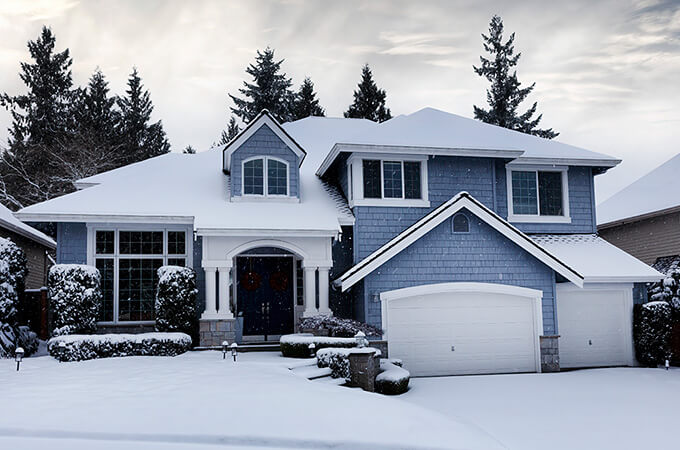 Blue home with a snowy roof
